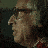 an older man wearing glasses and a shirt that says olympics