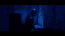 a man in a superhero costume stands in a dark room