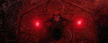 a woman is sitting on a table with red lights coming out of her hand