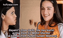 two women are talking to each other and smiling while standing next to each other .