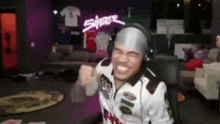 a man wearing headphones is sitting in a chair and smiling