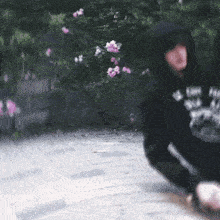 a blurry picture of a person wearing a black hoodie that says i love you