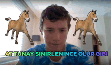 a young man stands in front of animated horses with the words at tunay sinirlenince olur gibi above him