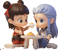 a boy and a girl sitting at a table with food