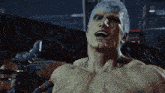 a man with a tattoo on his chest that says s on it