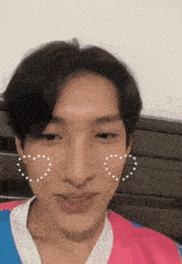 a close up of a young man 's face with a heart on his cheek