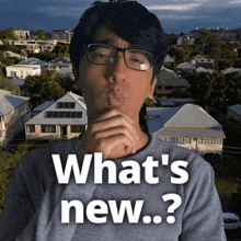 a man wearing glasses and a gray shirt says what 's new