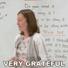 a woman stands in front of a white board with the words " do you mind if " on it