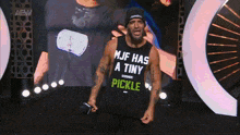 a man wearing a tank top that says ' mjf has a tiny pickle '