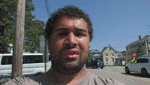 a man taking a picture of himself with a stop sign in the background