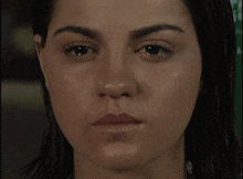 a close up of a woman 's face with a slight smile on her face