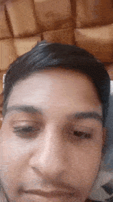 a close up of a man 's face with his eyes closed and his mouth open