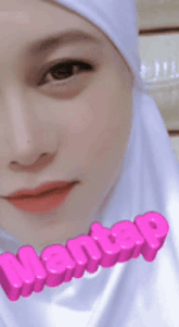 a close up of a woman 's face with the word wanitap written in pink