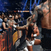 a wrestler is kneeling down in front of a banner that says thunder dumb