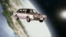 a silver lincoln continental is flying through the air