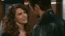 a man and woman are looking at each other and smiling