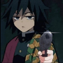 a person is holding a gun in their hand .