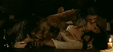 a man is biting a woman 's leg while another man watches