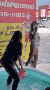 a woman is standing in a pool in front of a sign that says " 151465 "