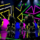 a group of people are dancing in front of a neon star