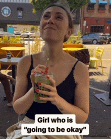 a woman drinking a green drink with a straw and a caption that says girl who is going to be okay