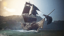 a large ship with black sails is floating in the water