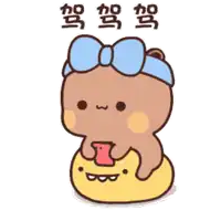 a cartoon bear with a blue bow is sitting on a yellow ball and holding a cell phone