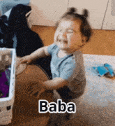 a baby is sitting on the floor and crying with the word baba above him