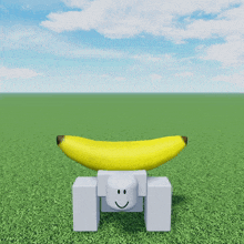 a yellow banana sitting on top of a white block with a smiley face on it