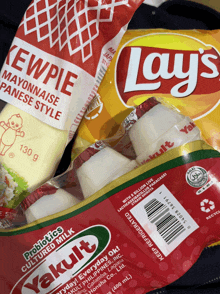 a bag of lay 's chips sits next to a bag of kewpie mayonnaise