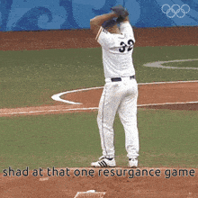 a baseball player with the number 32 on his jersey stands on the field