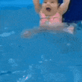 a blurry picture of a child in a pool