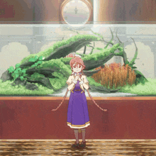a girl in a purple dress is standing in front of a large aquarium