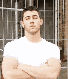 a man in a white t-shirt with his arms crossed