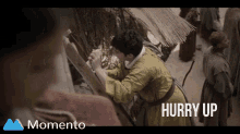 a screenshot of a momento video with a man reaching for something