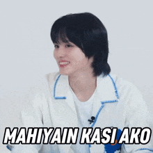 a woman in a white shirt is smiling with the words mahiyain kasi ako written below her