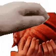 a close up of a person 's hands covering their face with a white object .