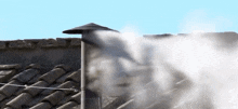 smoke is coming out of a chimney on the roof