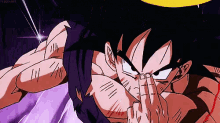 goku from dragon ball z is covering his face with his hand .