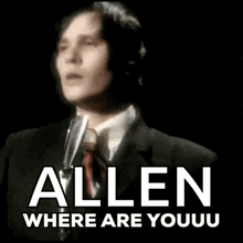 a man in a suit and tie is singing into a microphone with the words allen where are youuu below him
