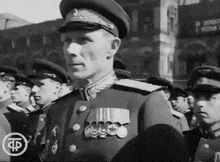 a black and white photo of a man in a military uniform with the letter f on the bottom