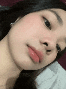 a close up of a woman 's face with red lipstick