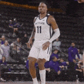a basketball player wearing a butler jersey number 11