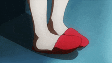 a pair of red slippers on a person 's feet