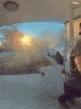 a person standing in front of a white truck with the word nest on the bottom right