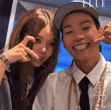 a man and a woman are posing for a picture with the number 1588 in the upper right corner