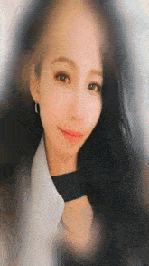 a woman with long black hair is wearing a white shirt and a black choker
