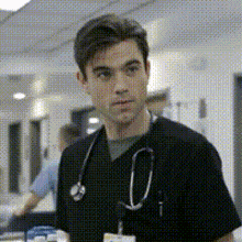 a man with a stethoscope around his neck is wearing a black scrub