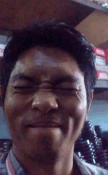 a close up of a man making a funny face
