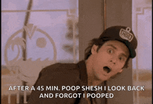 a man wearing a hat that says ' poop ' on it looks back and forgets he pooped